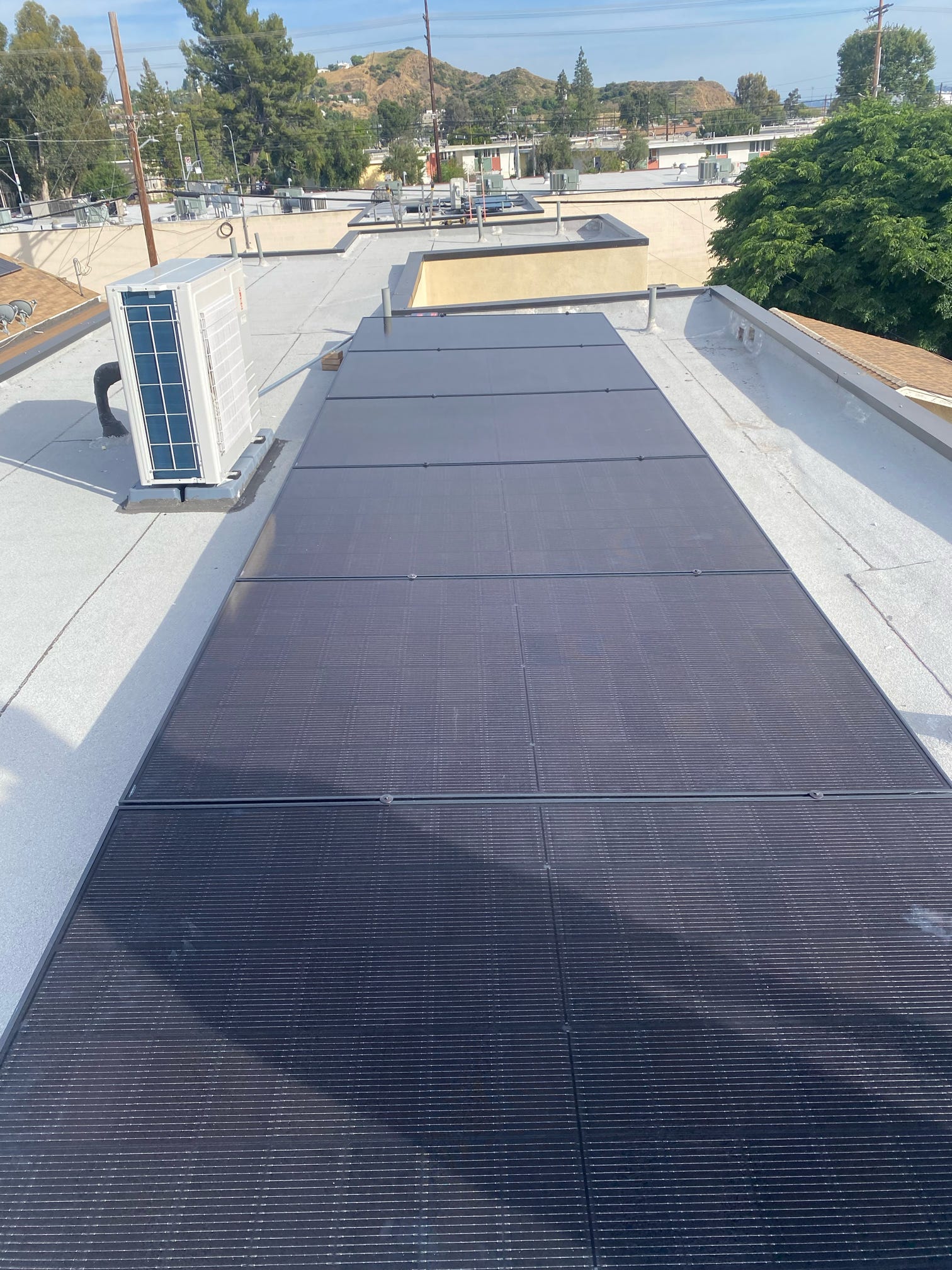 Aerial view of a finished rooftop solar project